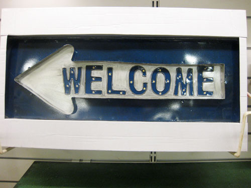 blue metal welcome sign